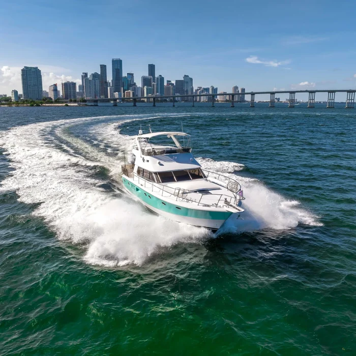 58 feet Palmer Johnson yacht cruising the water with the Miami skyline in the background